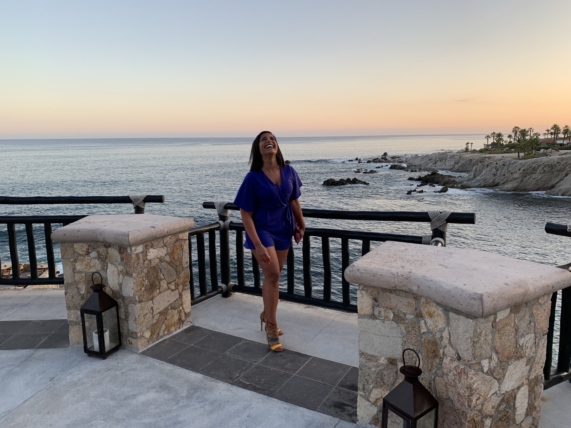 Jackie Roby standing on a patio by the ocean